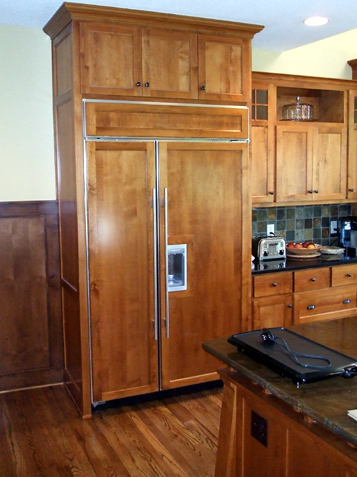 Refrigerator has wood paneled front