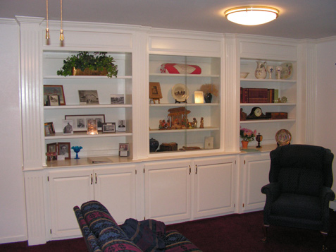 Display Bookcases - Center Bookcase has Glass Sliding Doors with lower Base Cabinets with Raised-Panel Doors