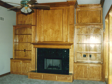Fireplace with Base Cabinets & Upper Bookshelves, Fluted Columns, Raised Panel Hearth Paneling above Bookcases - Mantle returns to Column Faces